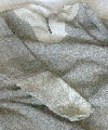 Replica low status, coarse, kempy twill, early medieval tunic artificially distressed, patched and darned to simulated typical use, wear and tear